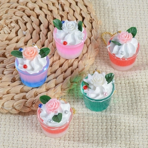 Miniature resin cupcake keychains with colorful bases and creamy floral tops