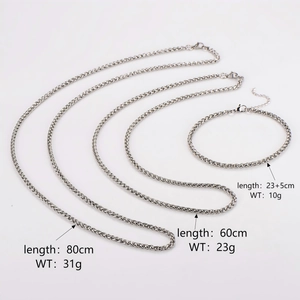 Three minimalist stainless steel chain necklaces in various lengths on a white background
