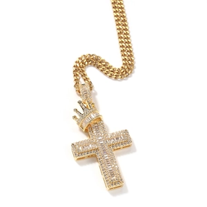 Macro shot of gold cross pendant with crown design and shimmering cubic zirconia stones