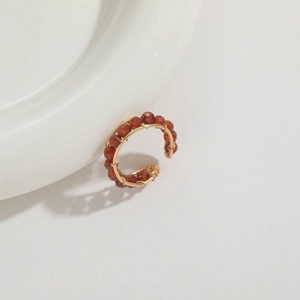 Close-up of handmade 14K gold plated wire wrapped ring with dark red garnet beads