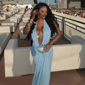 Close-up of light blue mesh V-neck top with tie back details on a female model