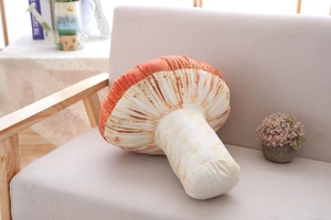Realistic orange mushroom plush pillow case on a grey sofa in a cozy home setting