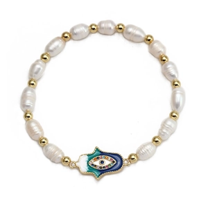 Detail of Hamsa Hand and Evil Eye charm with freshwater pearls on golden bracelet
