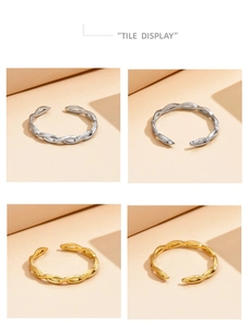 Detail view of woven braided texture on gold and silver open stainless steel rings