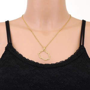 Close-up of a gold Reunion Island map pendant necklace worn on a person's neck