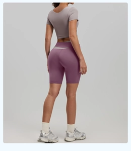Back view of high-waist purple fitness shorts and short-sleeve yoga top on model
