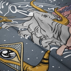 Detail of soft fabric tapestry featuring gold horns and bull head astrology pattern