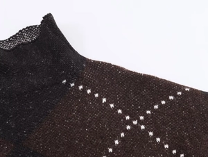 Detailed macro view of dark knit sweater fabric with white diamond grid patterns