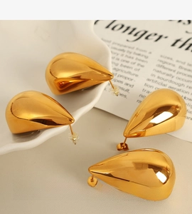 Macro shot of large 18k gold plated teardrop earrings with a mirror polished finish