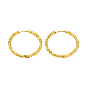 Chic twisted gold hoop earrings with minimalist metal texture on white background