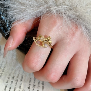 Detailed close-up of a golden rocking horse ring with sparkling zircon inlays on hand