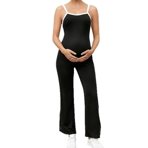 Black maternity jumpsuit with white trim straps and flared legs for yoga or casual wear