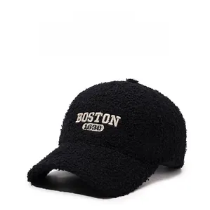Close-up of black teddy fleece baseball cap featuring white Boston 1630 letter embroidery