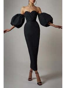 Close-up of elegant puff sleeves and off-shoulder neckline on a black evening dress