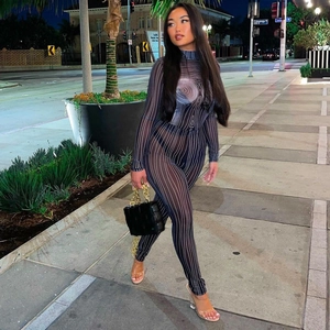 Detail of sheer black striped mesh jumpsuit with abstract print in street setting