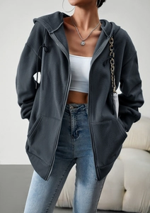 Detailed texture of dark grey fleece zip-up hoodie featuring warm soft fabric and pockets