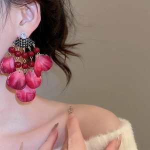 Detailed close-up of long vintage red floral petal tassel earrings with crystal studs