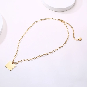 Close-up of 18k gold plated paperclip chain with square pendant and lobster clasp
