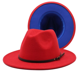 Detail of red fedora hat with blue lining and black leather belt featuring gold buckle