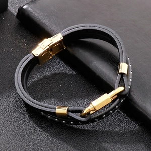 Detail of multi-layer leather bracelet showing stainless steel clasp and silver studs