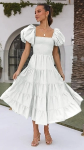 Detail of white puff sleeves and ruched bodice on a tiered summer midi dress