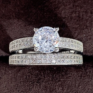 Sparkling silver solitaire bridal ring set with round cut diamond on dark velvet base