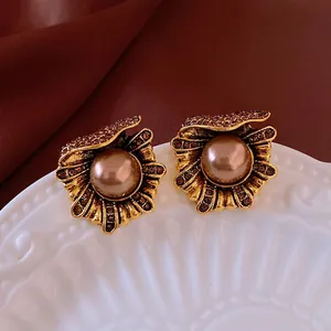 Vintage floral pearl earrings with brown crystals on an elegant velvet background