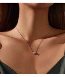 Elegant D-color moissanite heart necklace shown on a model neck with sparkling pendant