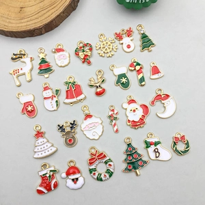 Close-up of assorted colorful enamel Christmas charms including Santa and reindeer