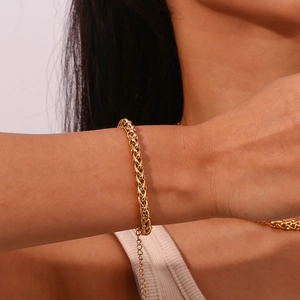 Detailed close-up of 6mm gold-plated stainless steel wheat chain bracelet with extension