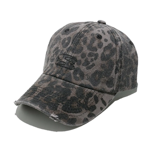 Detail of vintage leopard print baseball cap with distressed texture and S embroidery