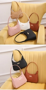 Detail of classic half-moon shoulder bags in multiple colors with leaf metal pendants