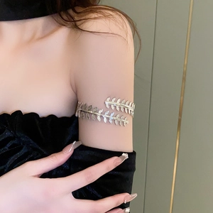 Detailed view of silver leaf-shaped wrap armlet with realistic leaf vein texture