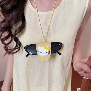 Detail of yellow pebbled leather eyewear holder with 3D cartoon cat and black sunglasses