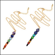 Detailed view of 7 chakra natural stone necklaces with gold chains and colorful round beads