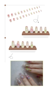 Macro detail of long coffin press-on nails with green ombre and pink planet art designs