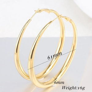 Detail view of 6mm thick gold drop hoop earrings with 61mm diameter size specifications