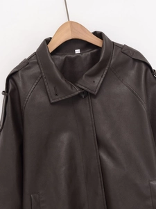 Detail view of coffee faux leather jacket showing collar lapels and shoulder epaulettes