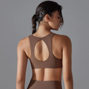 Macro view of seamless hollow-out back design on dark brown breathable sports bra