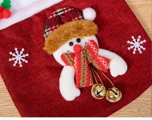 Detailed view of red burlap Christmas candy bag with 3D snowman and gold bells
