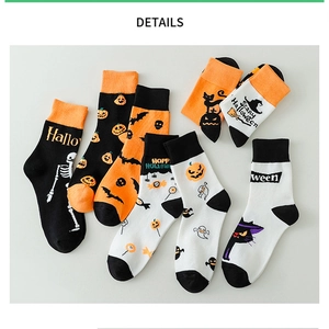 Detail shot of Halloween socks featuring pumpkin, ghost, and bat knit patterns