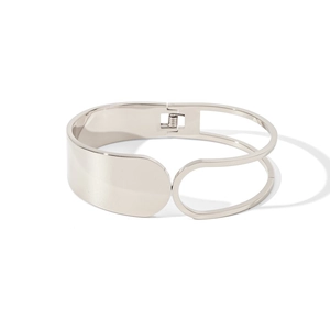 Minimalist silver wide metal bangle featuring an asymmetrical open frame design
