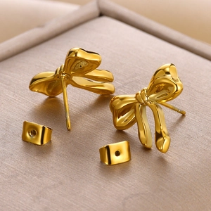 Macro shot of 18K gold-plated stainless steel bow earrings with high-polish mirror finish