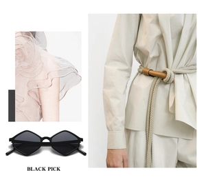 Chic black geometric diamond frame sunglasses shown with a cream woven belt and apparel