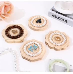 Close-up of geometric wooden jewelry display trays with natural wood grain finish