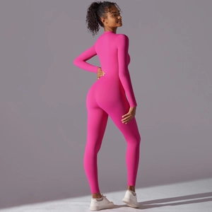 Detail view of pink long sleeve yoga bodysuit with body-shaping seams and slim fit