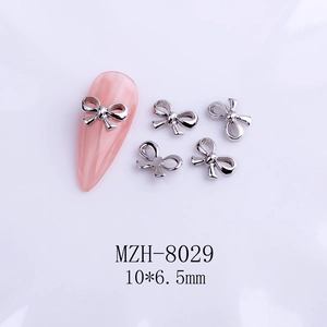 Silver bow nail charm with ribbon design and 10x6.5mm size detail for manicure art