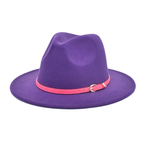 Detail of purple fedora wool hat featuring a pink leather band and metal needle buckle