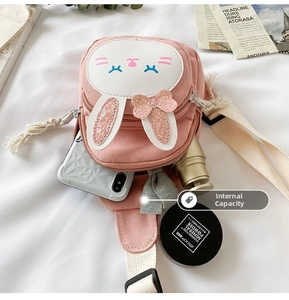 Internal capacity of pink rabbit crossbody bag showing space for phone and makeup