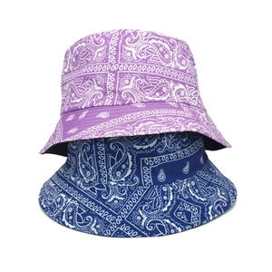 Double-sided paisley print bucket hats in purple and blue colors on a white background